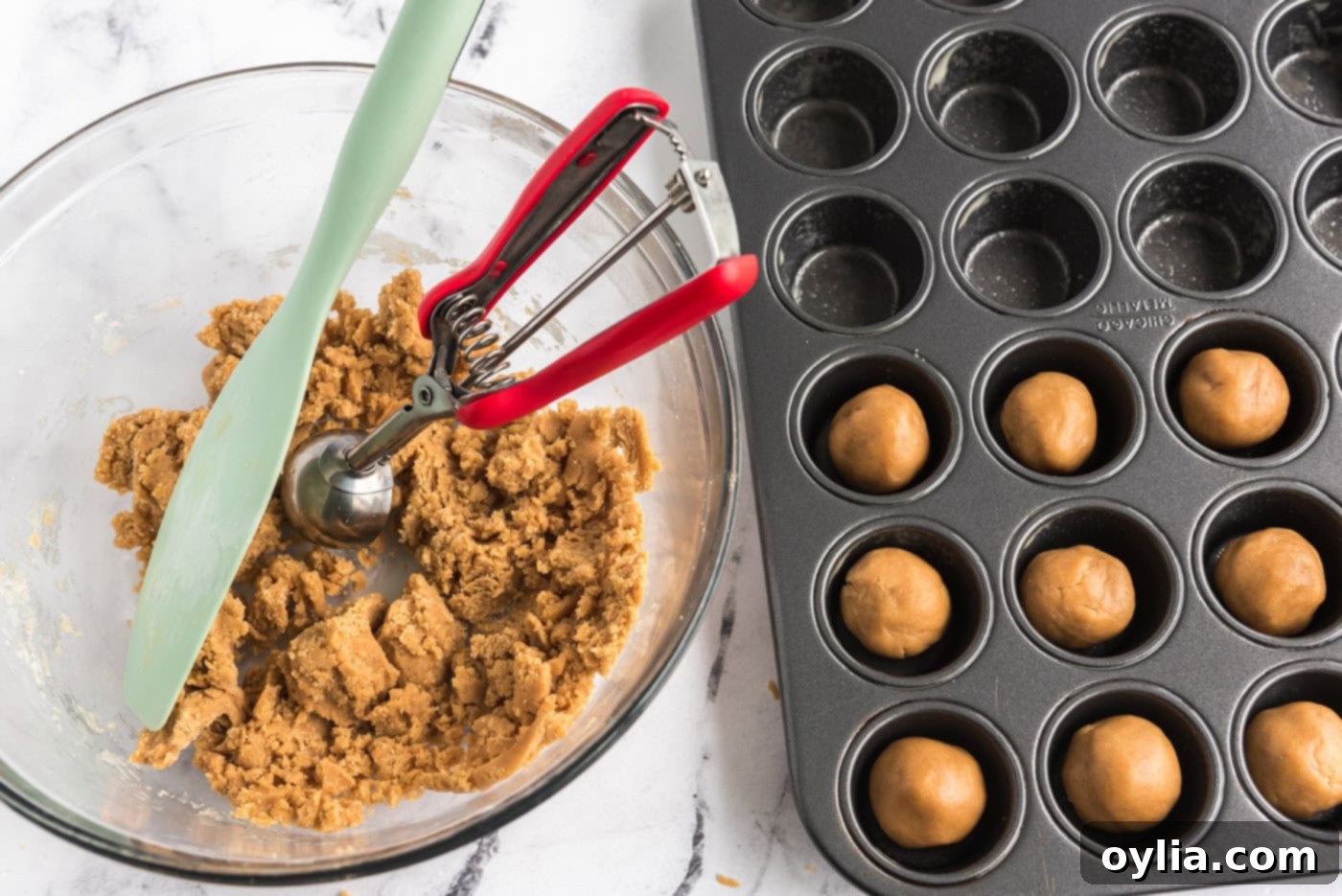 scooping 1 inch dough balls into a mini muffin pan