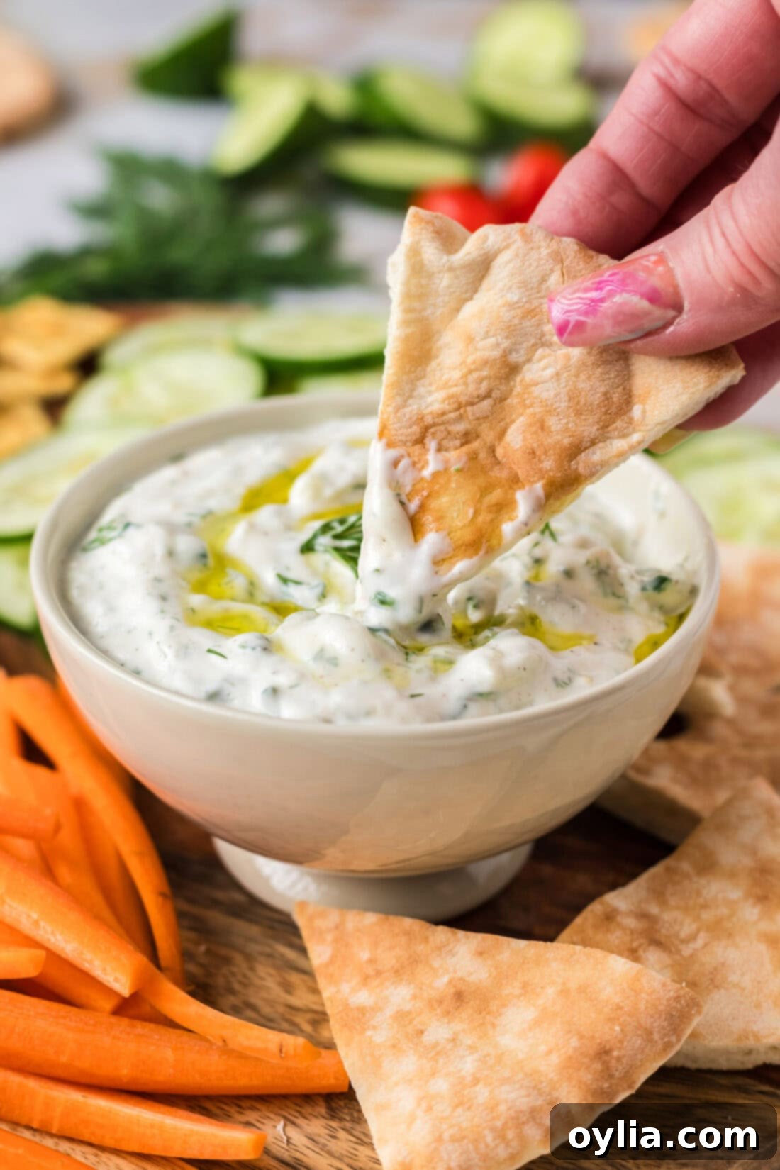 Refreshing Greek Tzatziki Dip 3 Pita bread being dipped in Tzatziki Sauce