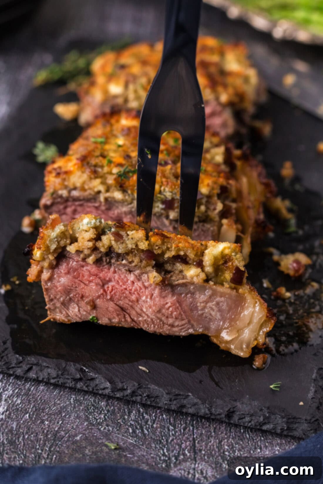 Meat fork in a piece of Blue Cheese Crusted Steak
