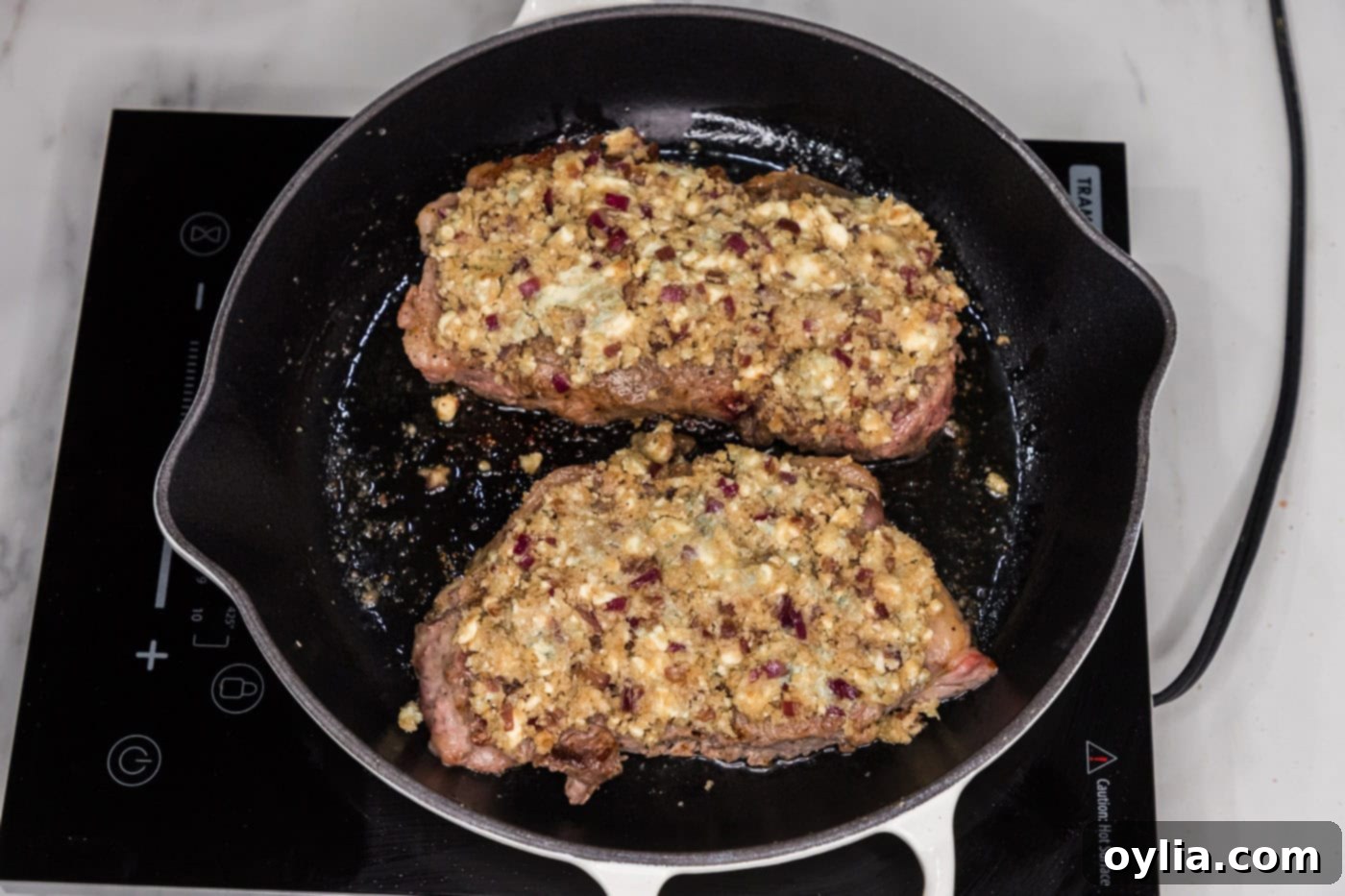 blue cheese crusted steak in a skillet