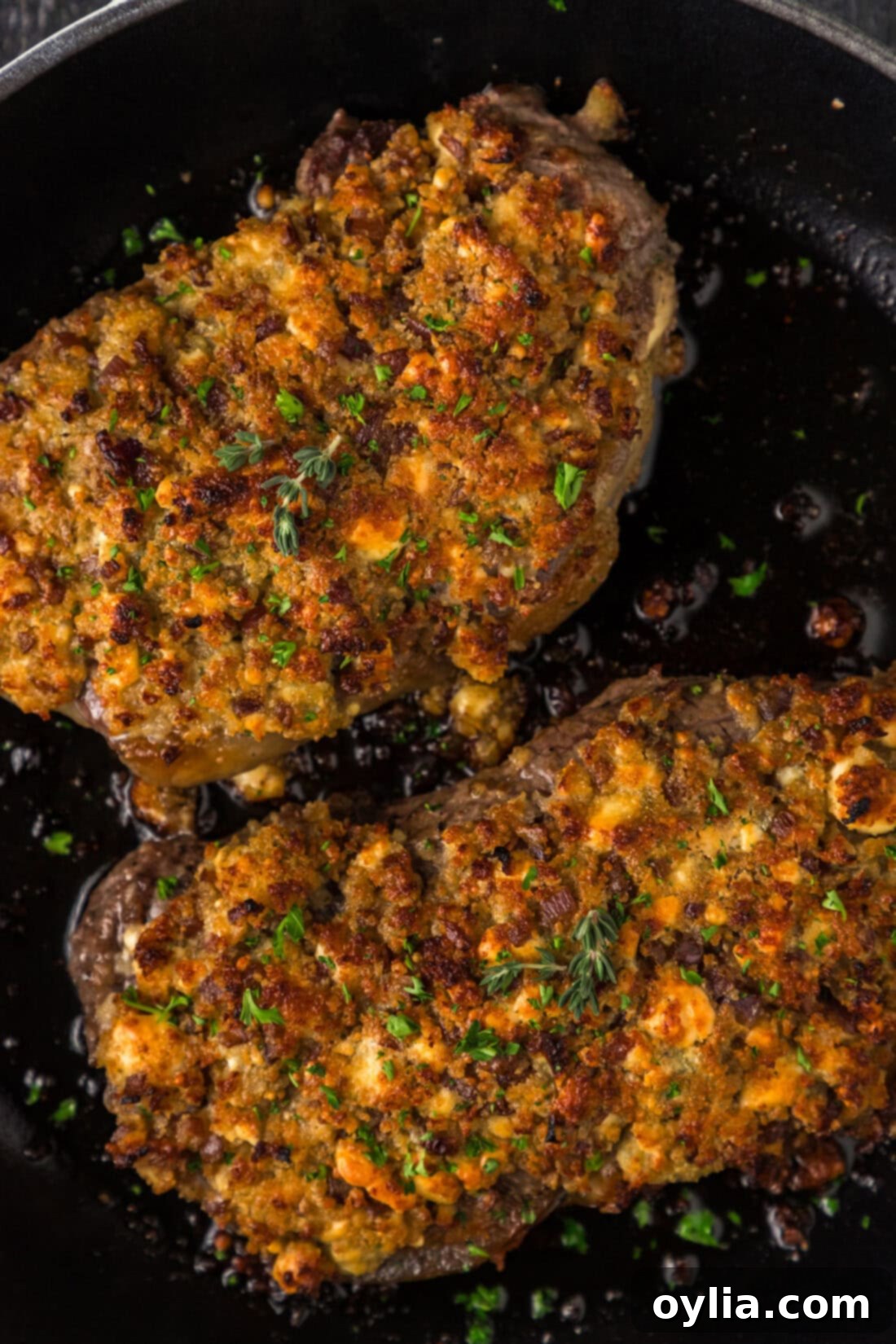 Blue Cheese Crowned Steak 3 Close up photo of two Blue Cheese Crusted Steaks in a skillet