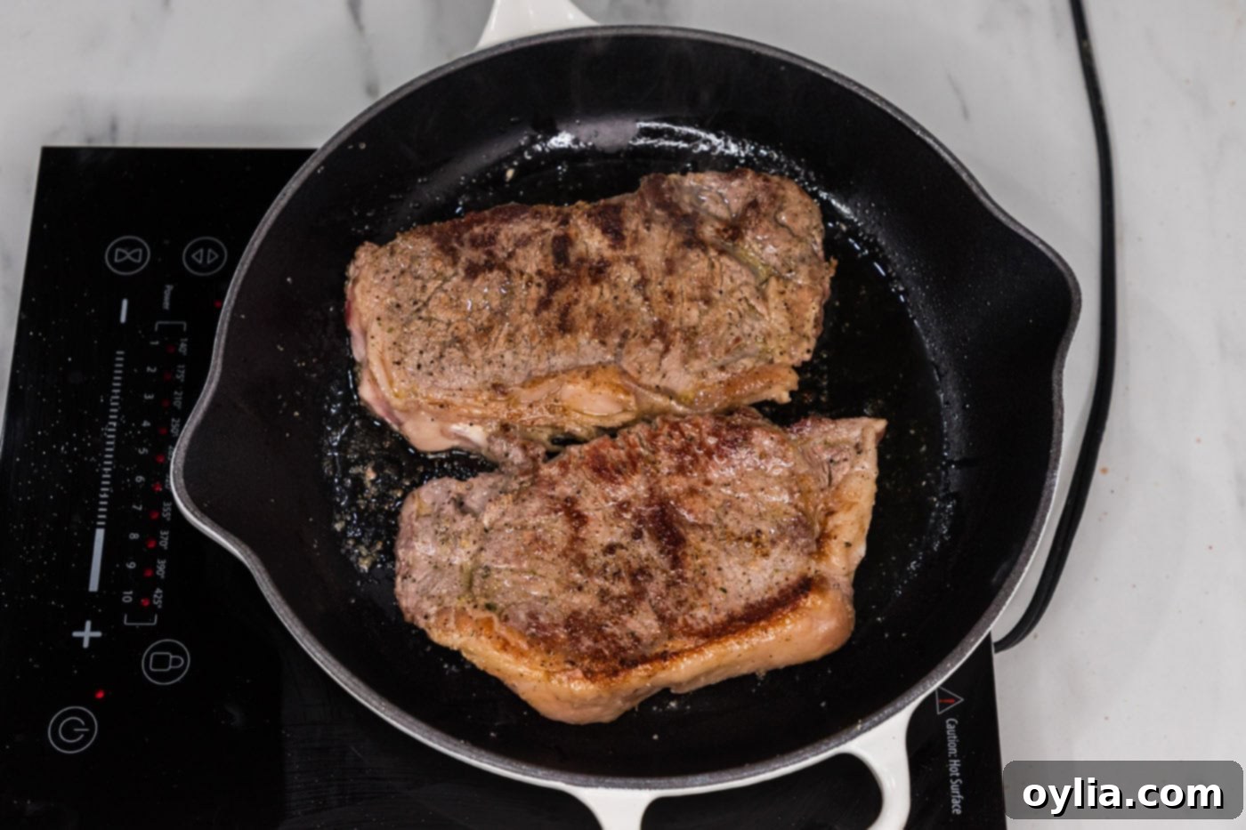 browned new york strip steak in a skillet
