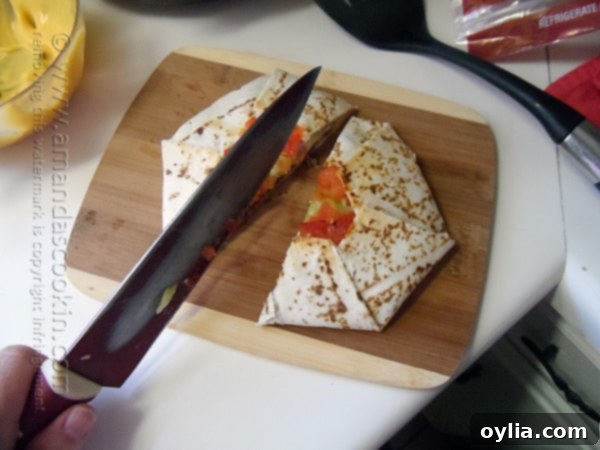 A freshly cooked and sliced homemade Crunchwrap Supreme on a wooden cutting board, ready to be served.