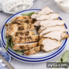 Juicy Slow Cooker Turkey Breast 16 sliced cooked turkey breast on a plate