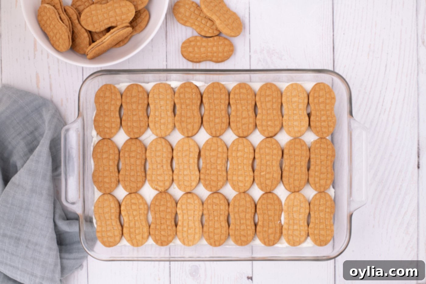 nutter butter cookies in a baking dish on top of whipped cream