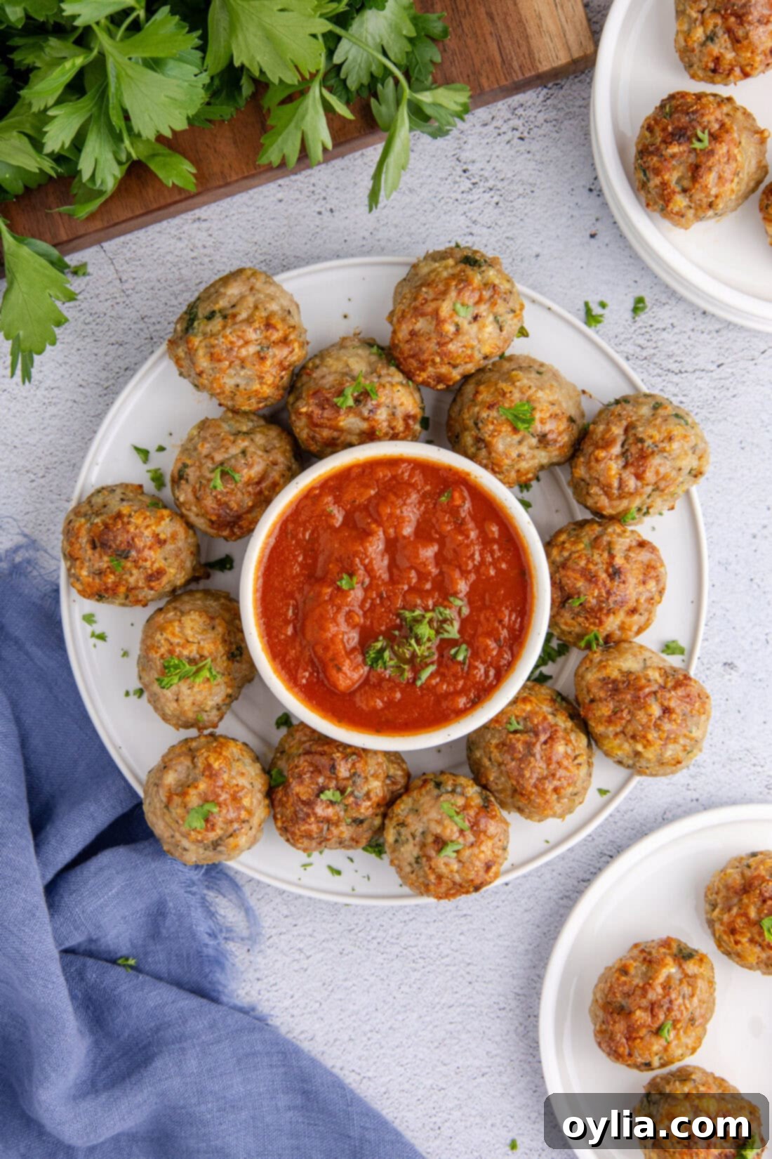 Plate of Chicken Meatballs with a bowl of marinara sauce