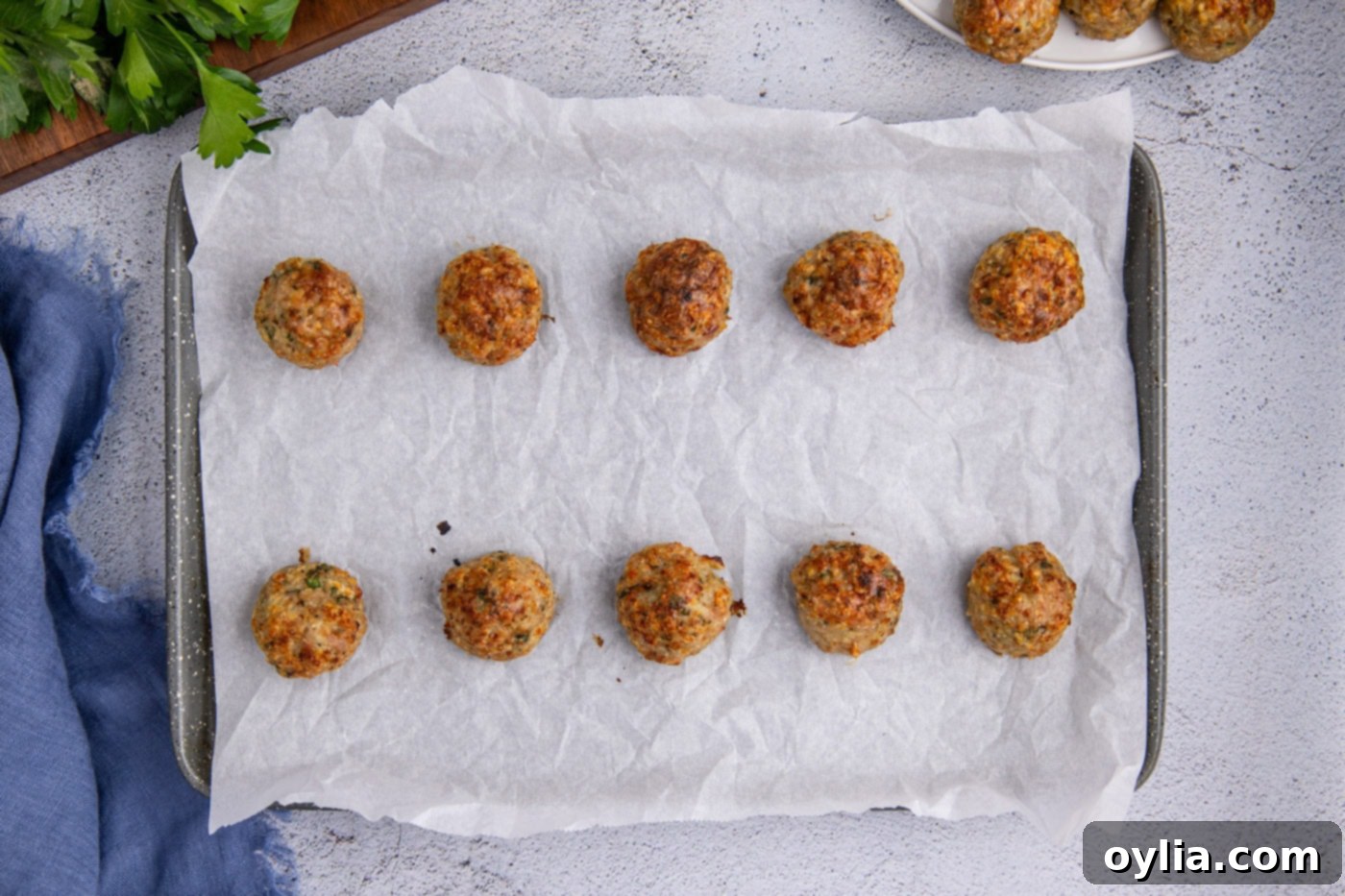 baked chicken meatballs on parchment paper