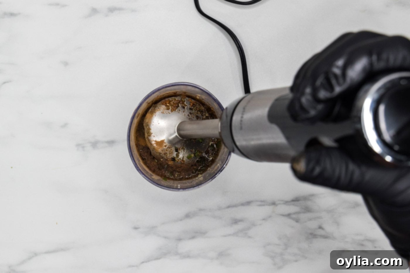 blitzing jerk chicken marinade ingredients in an immersion blender