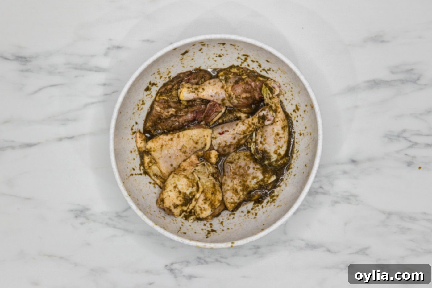 chicken in a large bowl coated in marinade