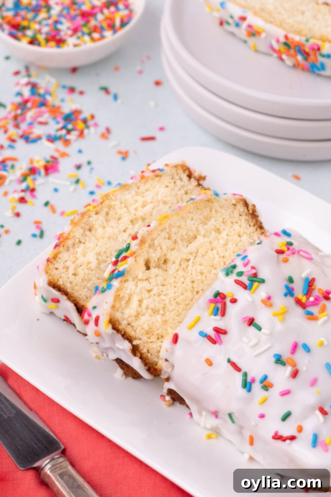 Ice Cream Bread on a plate with two slices cut, showcasing its soft texture
