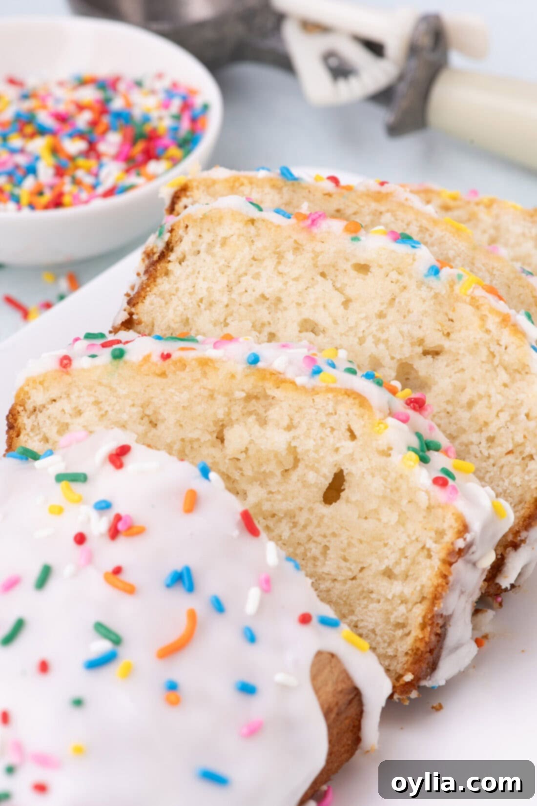 Close up photo of multiple slices of Ice Cream Bread, garnished with sprinkles