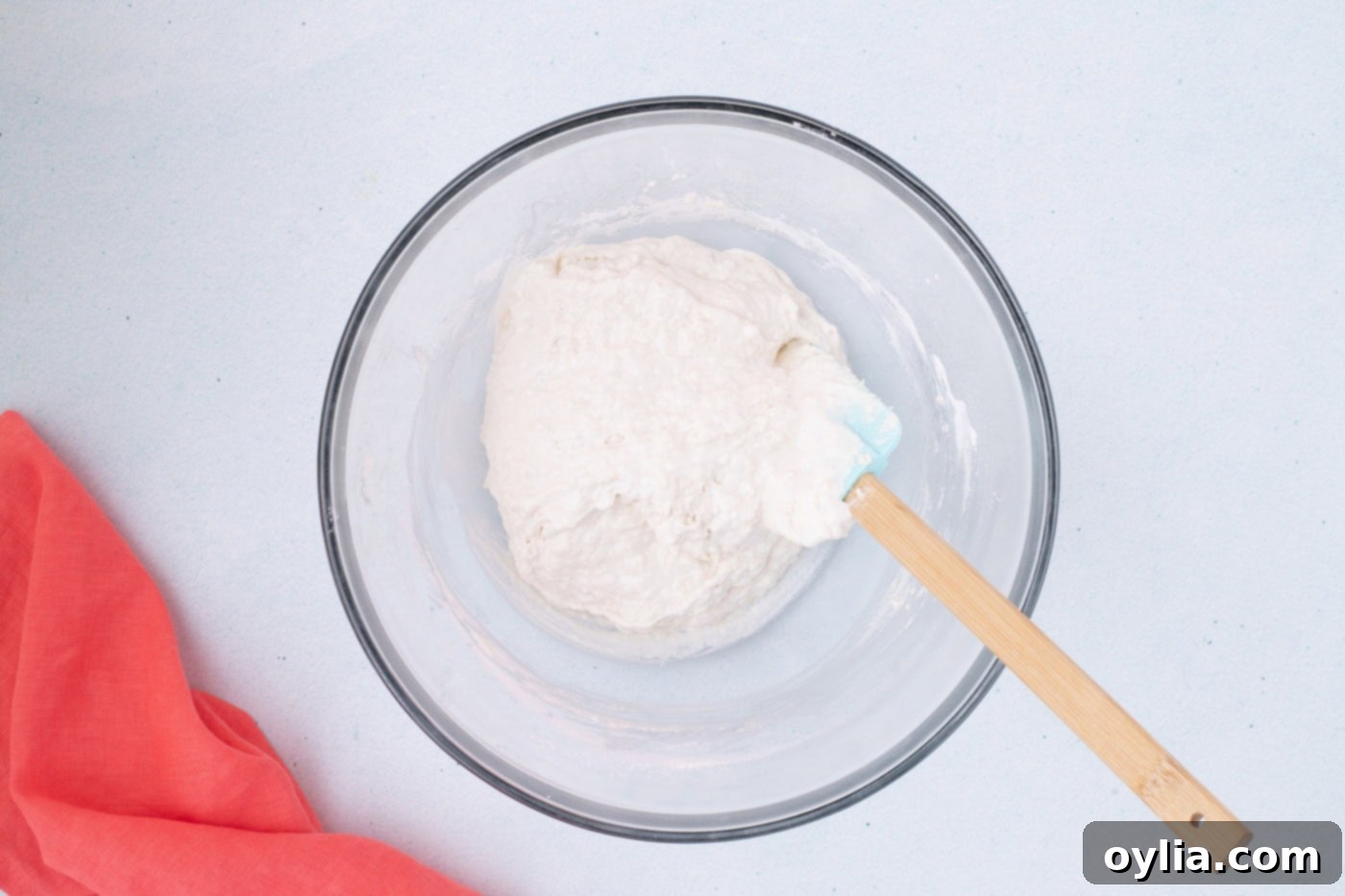 Vanilla ice cream and self-rising flour gently mixed in a bowl, showing a slightly lumpy batter