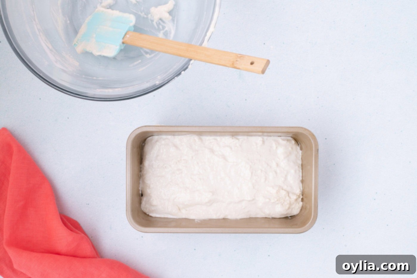 Ice cream bread batter evenly spread in a greased loaf pan