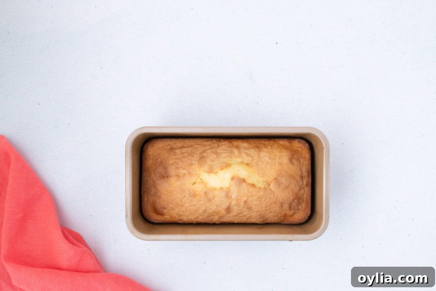 Freshly baked ice cream bread loaf cooling in its pan