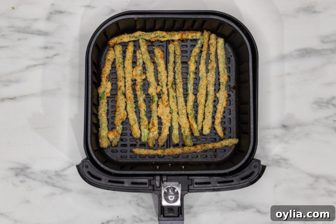 fried asparagus in air fryer basket