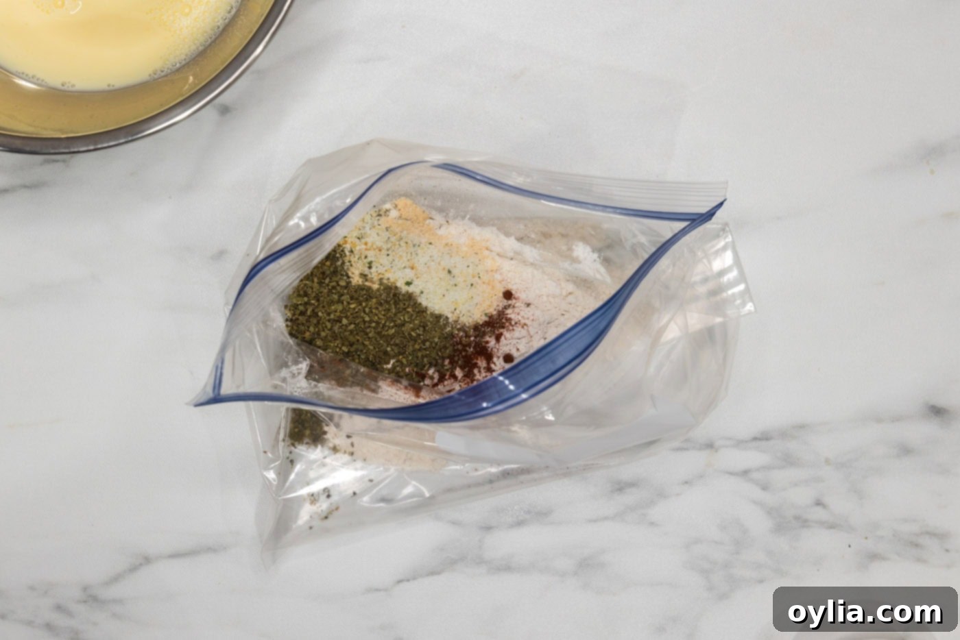 seasonings and flour in a large gallon sized zipper bag