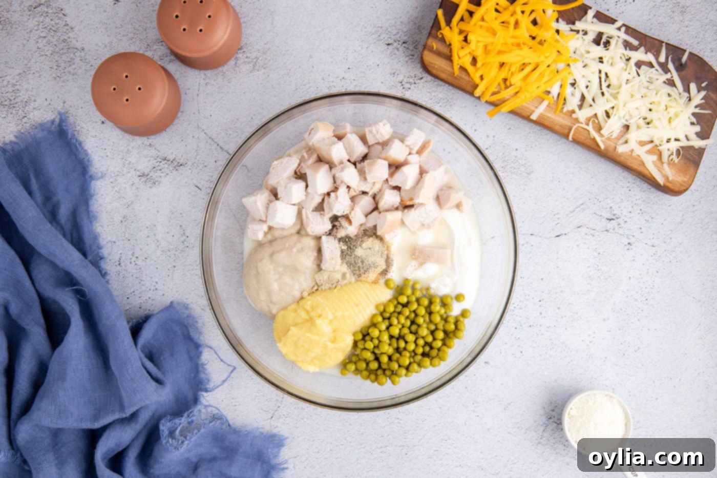 Turkey Tetrazzini 5 Cubed turkey, sour cream, peas, cream of chicken and mushroom soup, and seasonings in a mixing bowl for tetrazzini sauce