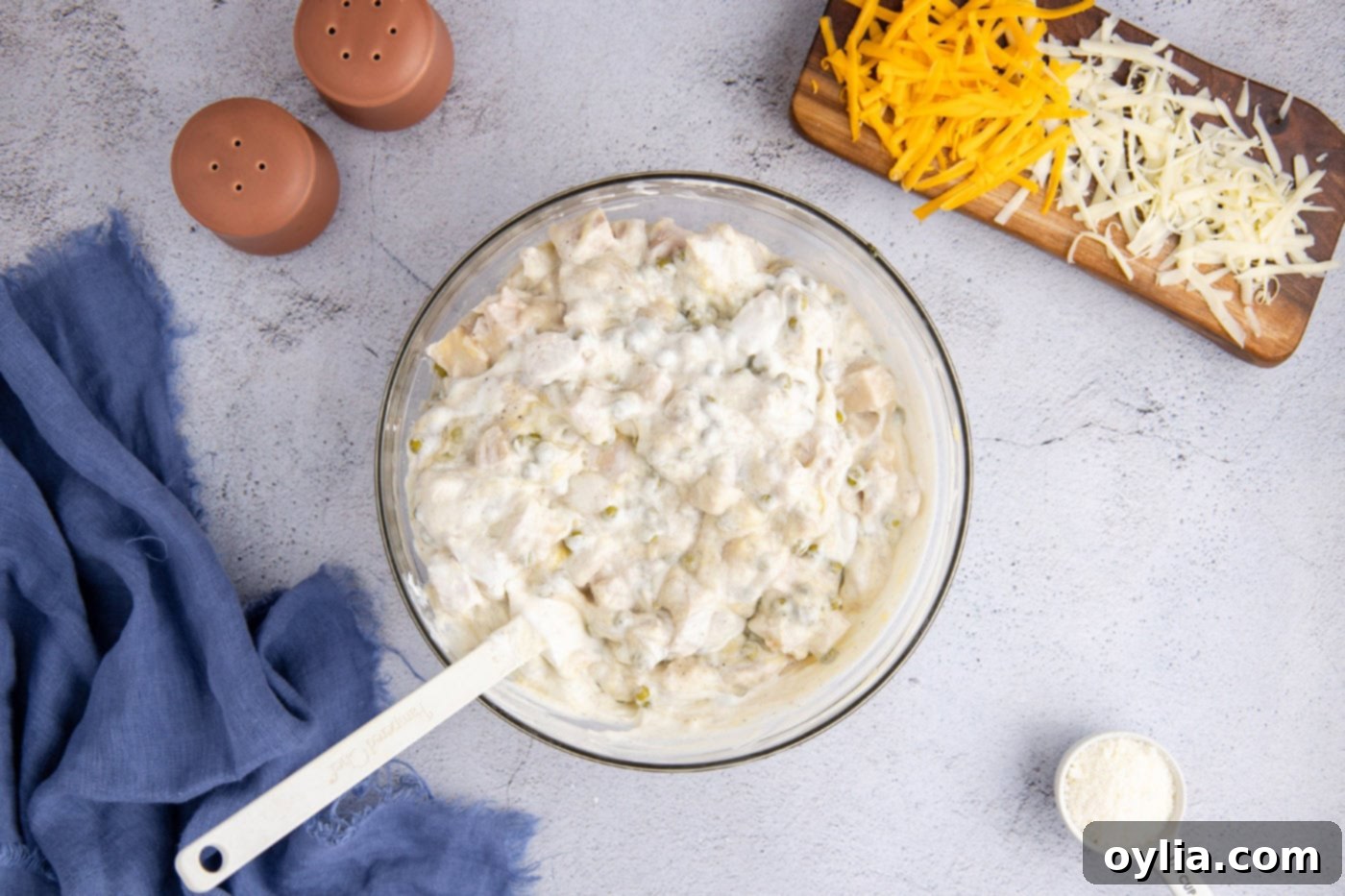 Turkey Tetrazzini 6 Creamy turkey tetrazzini sauce mixture in a large mixing bowl with a rubber spatula