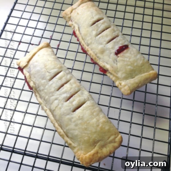 Golden-brown McDonald's style cherry pies cooling on a wire rack after baking