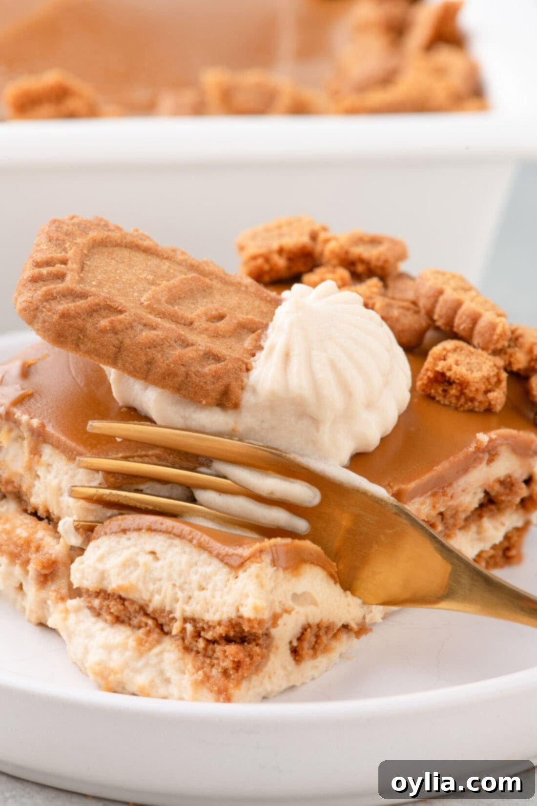 Fork breaking apart a piece of Biscoff Icebox Cake