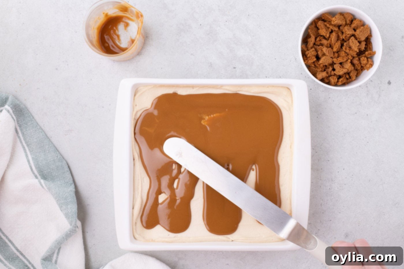 spreading cookie butter over Biscoff icebox cake