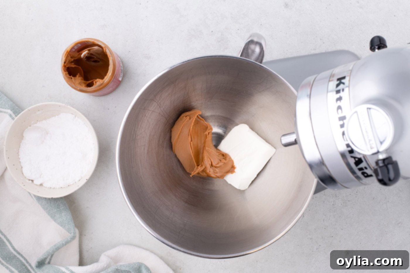 cookie butter and cream cheese in a stand mixer bowl