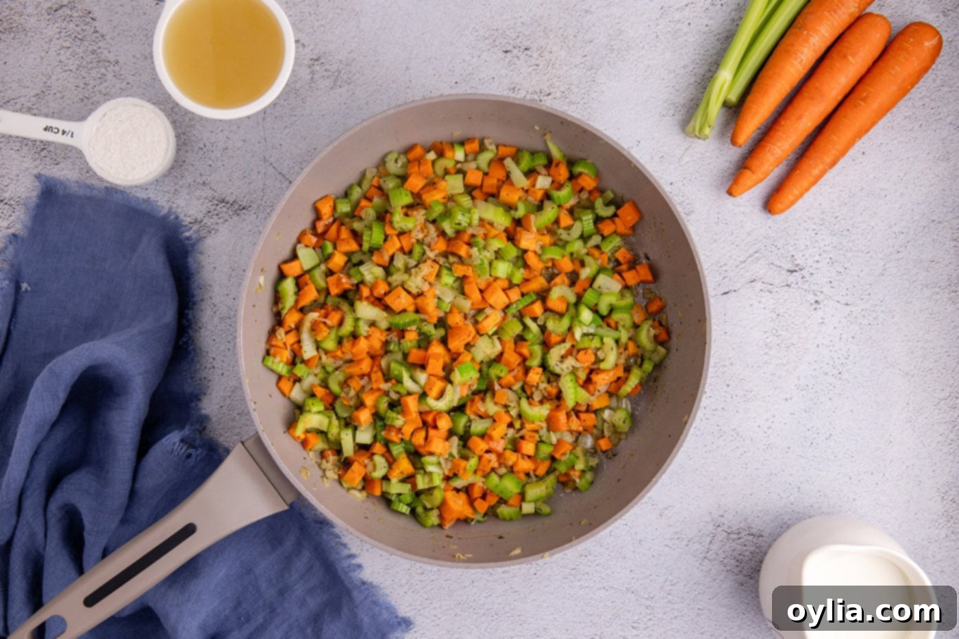 sauteed carrots, onion, and celery in a skillet with butter