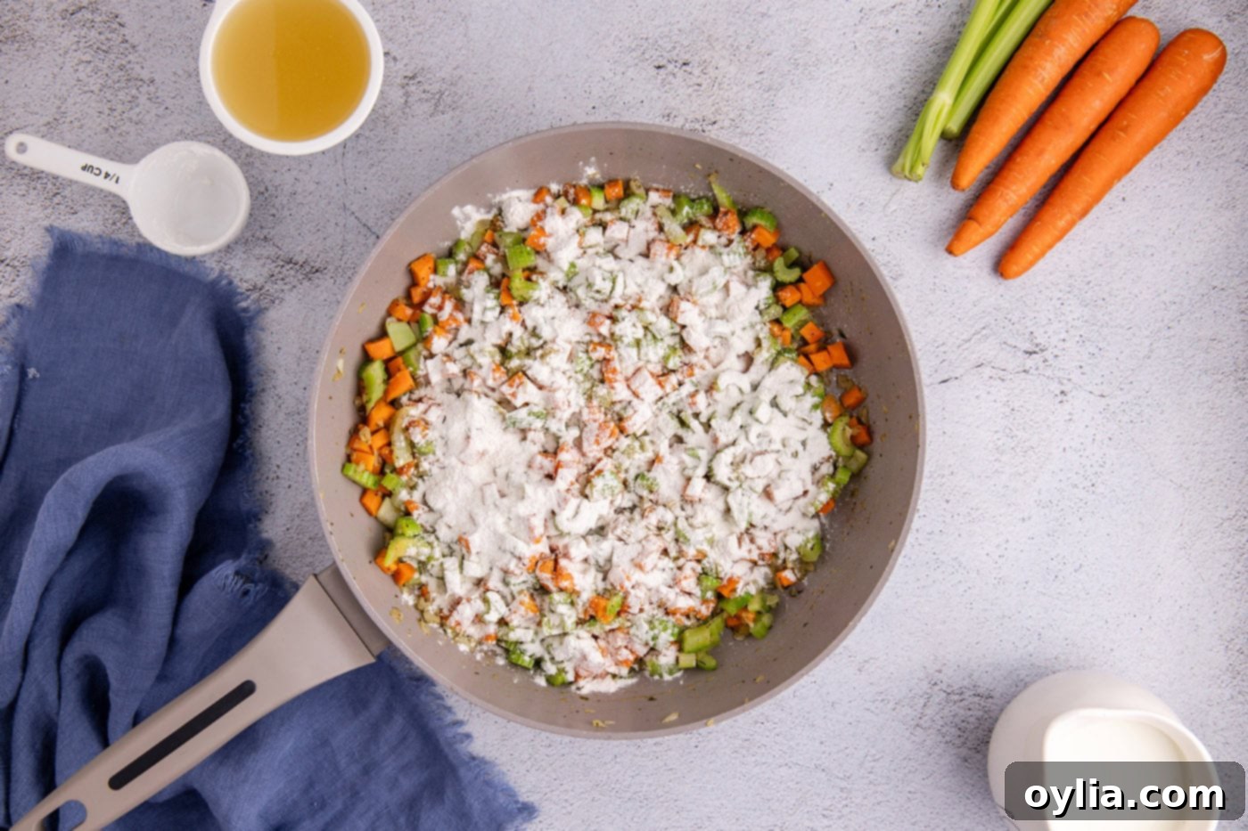 flour sprinkled over veggies in a skillet