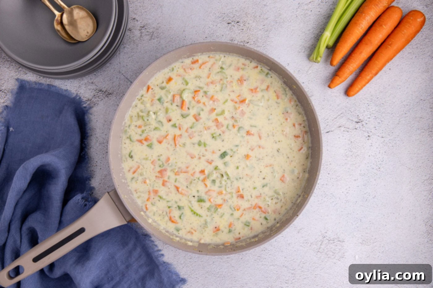 milk and chicken stock added to pot pie mixture in a skillet