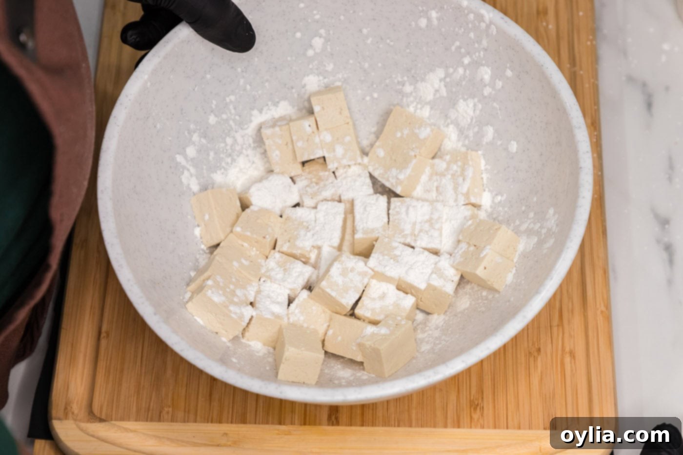 cubed tofu with cornstarch on top in a bowl