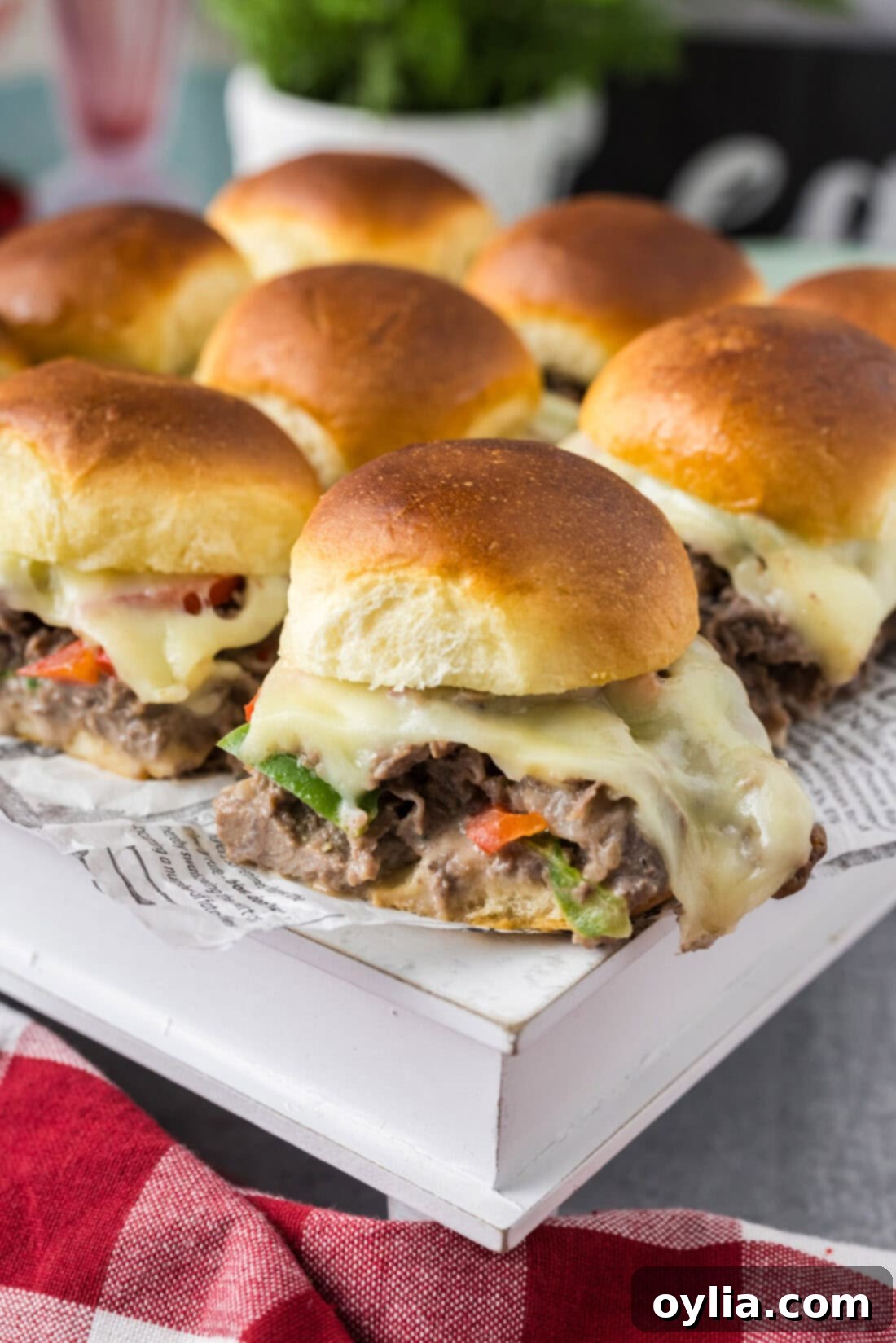 Philly Cheesesteak Sliders on a white serving board
