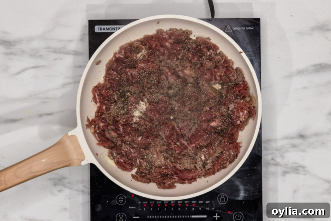 browned shaved beef in a skillet