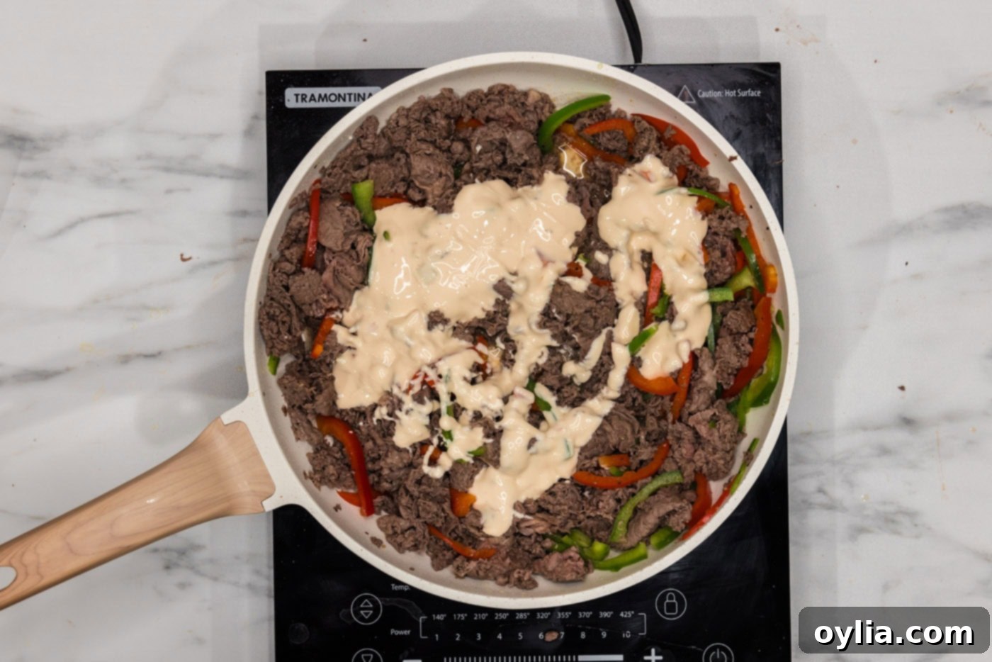 queso blanco added to skillet with bell peppers and beef