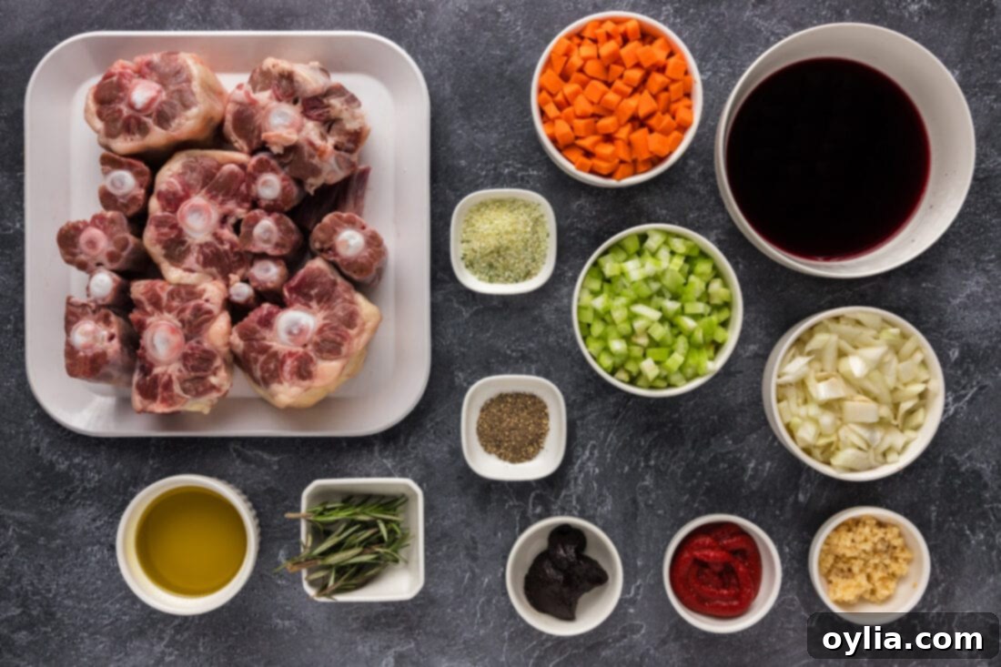 Tender Slow Braised Oxtail 4 Assortment of fresh ingredients for Braised Oxtail, including oxtail pieces, red wine, carrots, celery, onions, and rosemary.