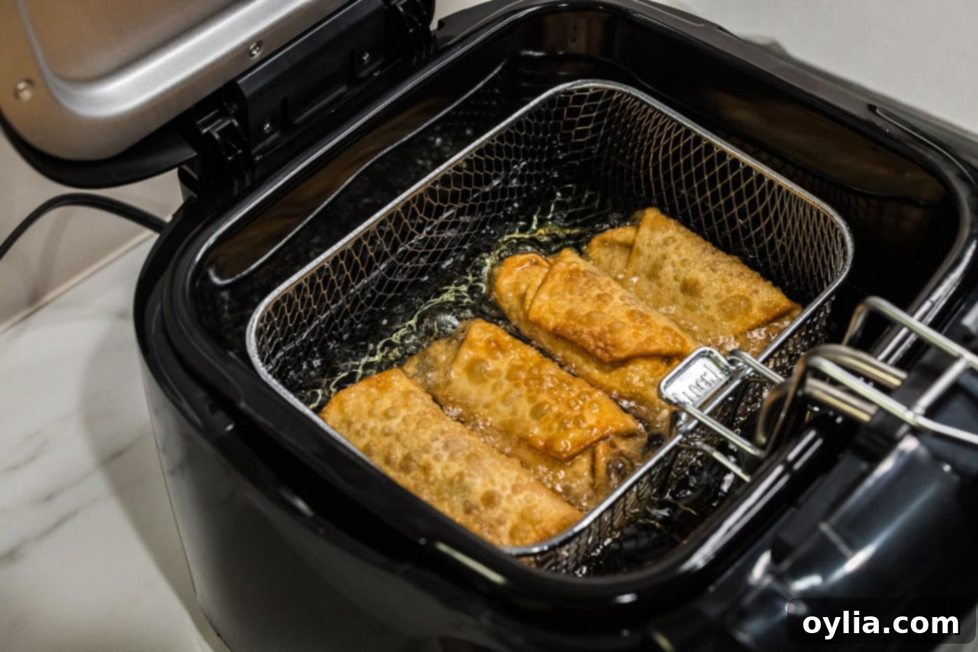 deep fried egg rolls in fryer basket