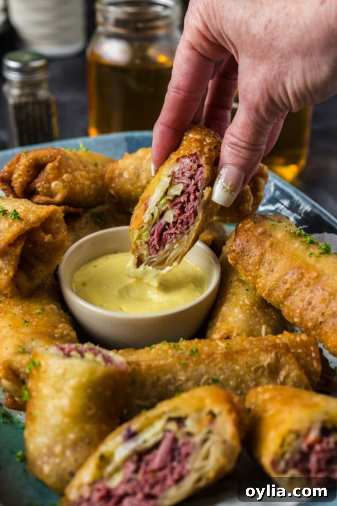 Half a Corned Beef Egg Roll dipping in dressing