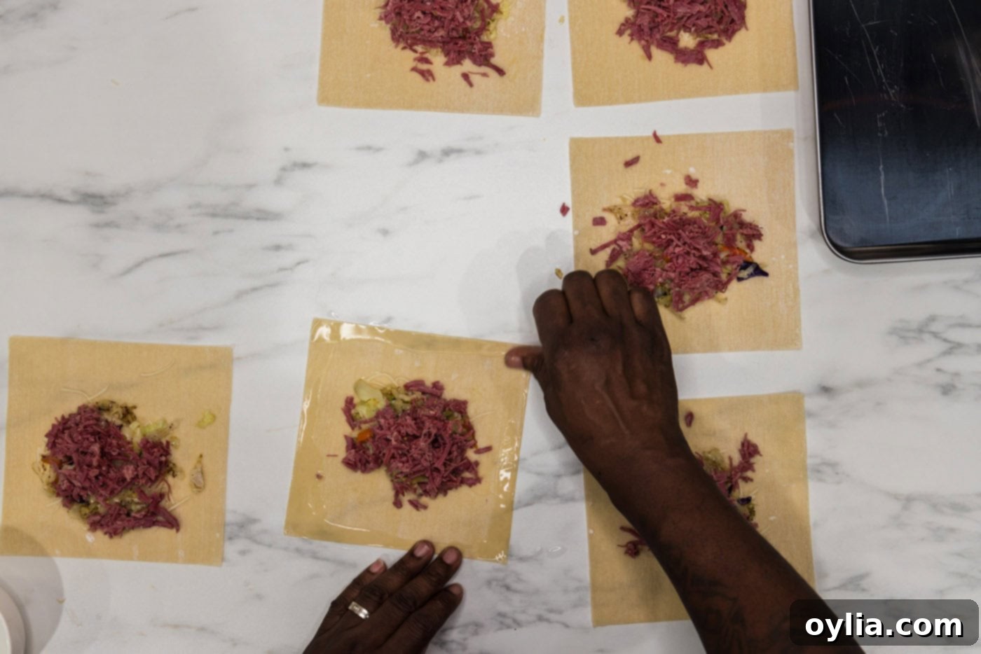 wetting the edges of egg roll wrappers with water