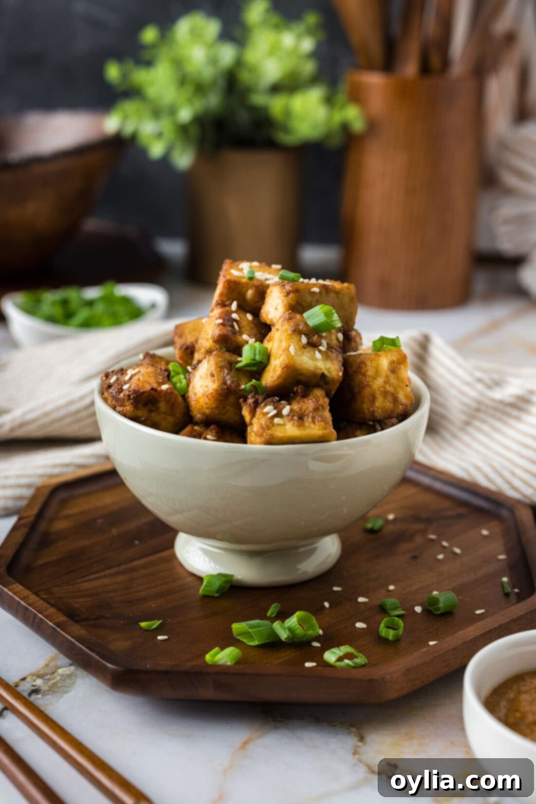 Bowl of golden, perfectly air-fried tofu cubes, ready to be served or incorporated into a meal.