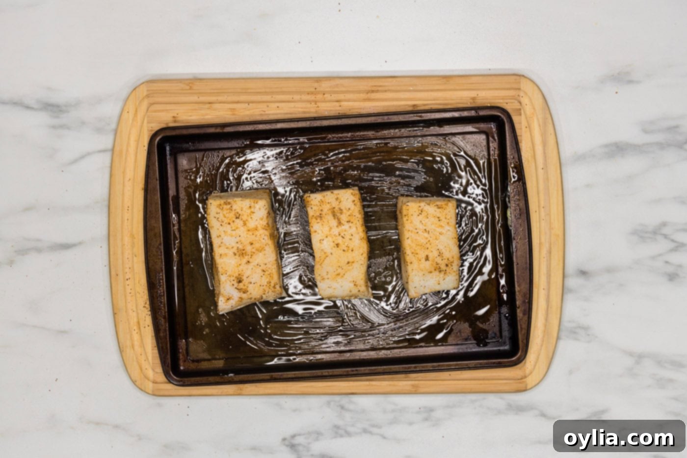 chilean sea bass filets on a baking sheet