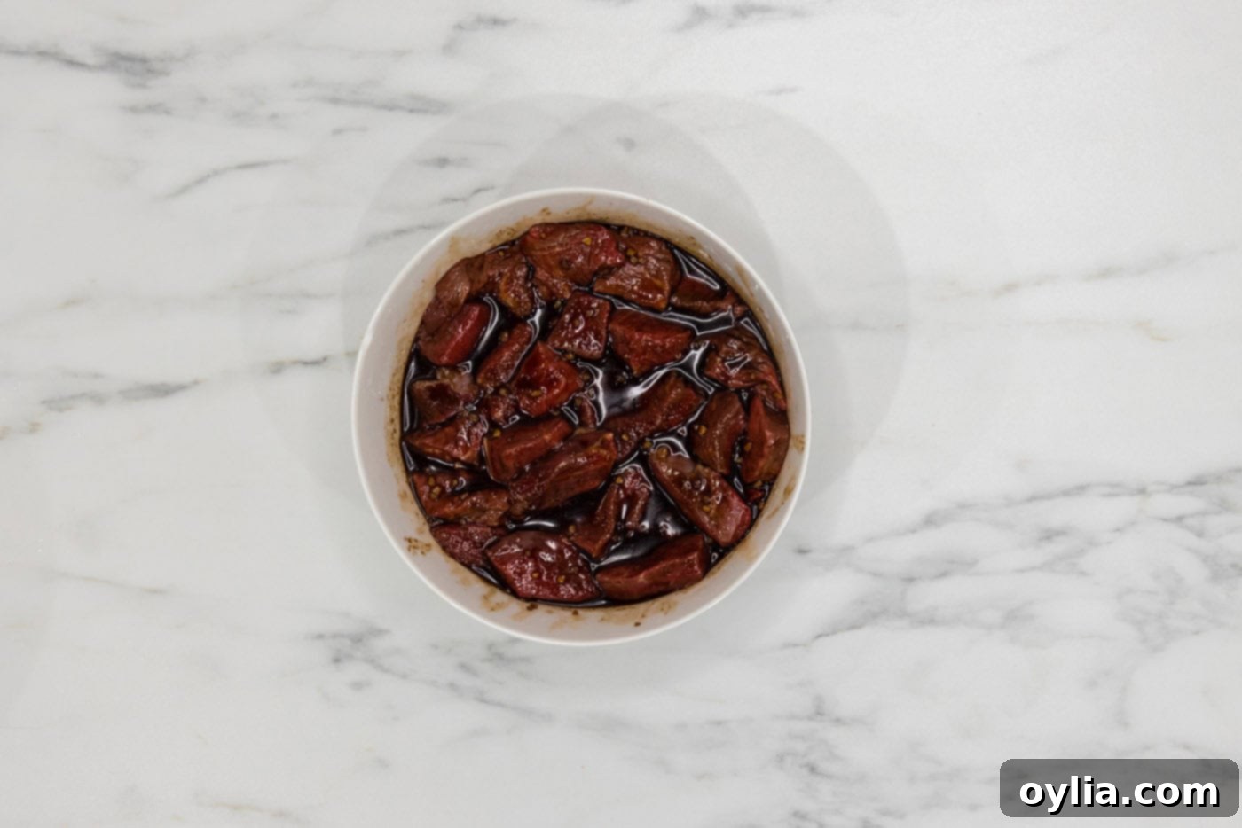 steak marinating in a bowl