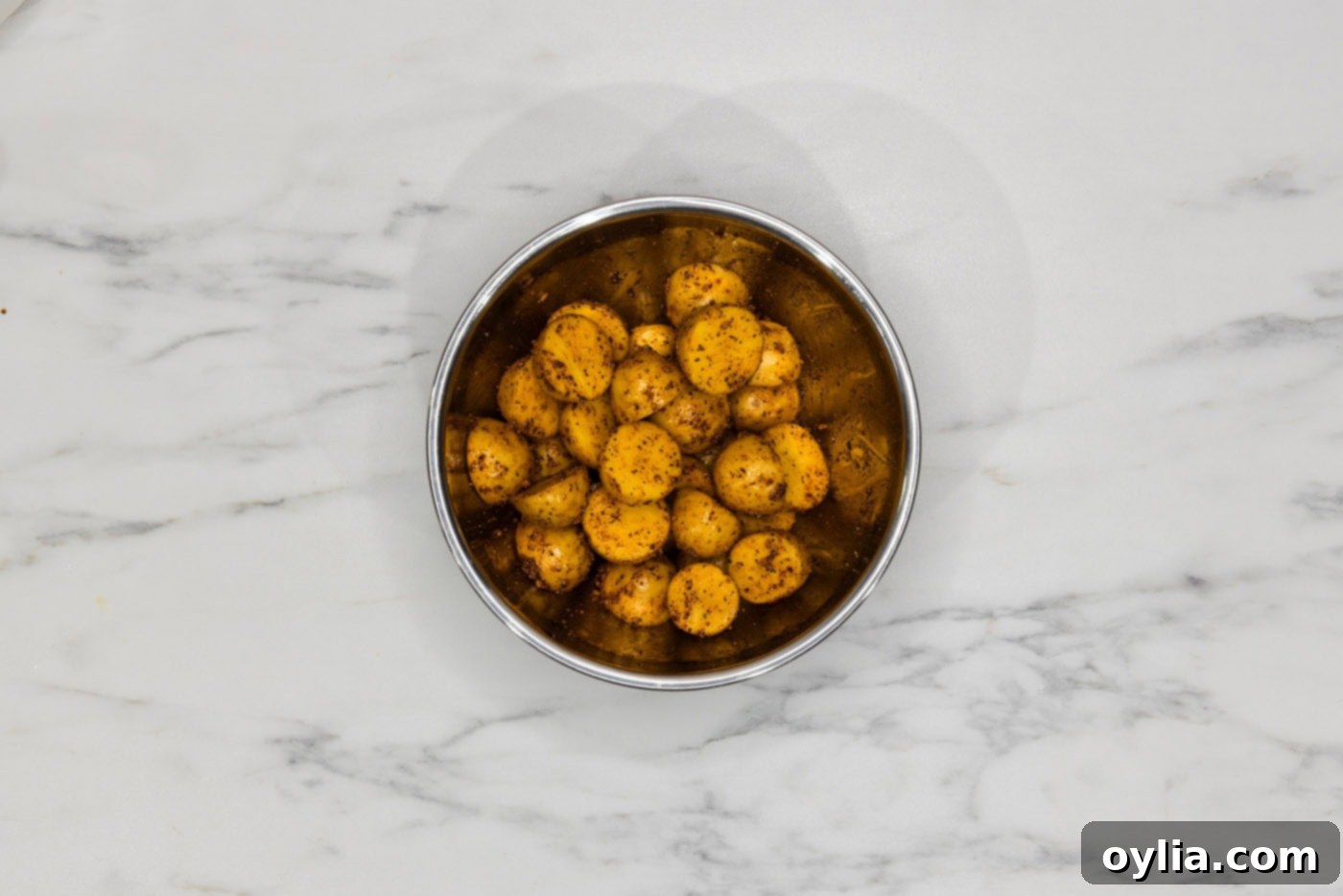 seasoned baby potatoes in a mixing bowl
