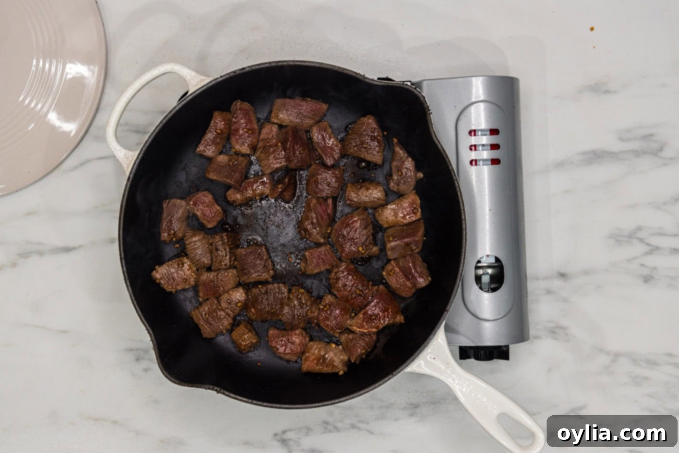 cubed steak cooking in a skillet