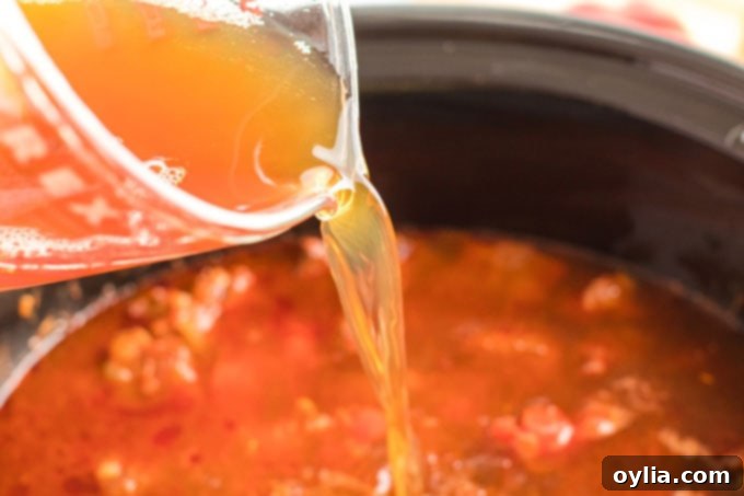 adding broth to crockpot