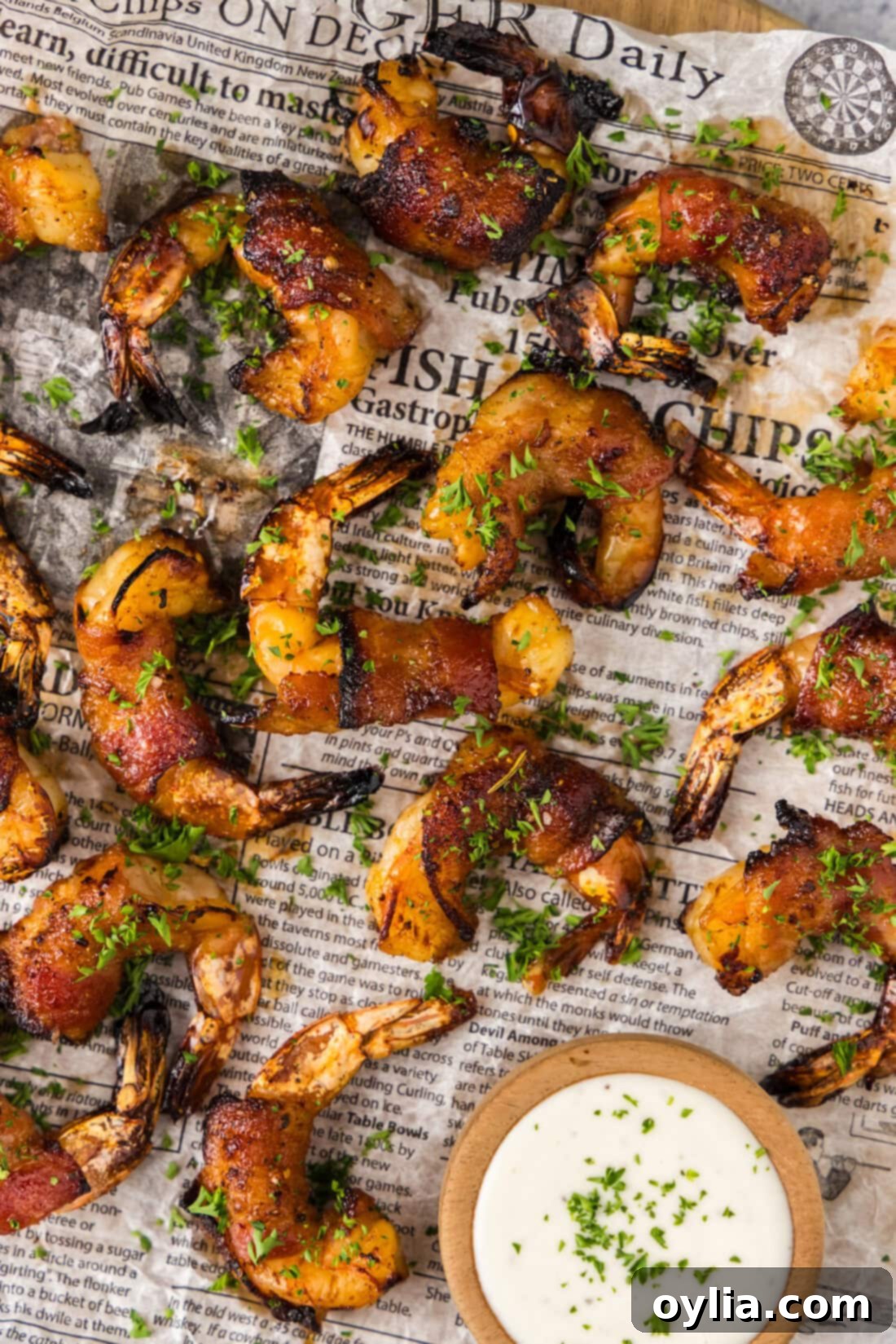 Crispy Air Fryer Bacon-Wrapped Shrimp 2 Close up photo of Air Fryer Bacon Wrapped Shrimp on parchment paper