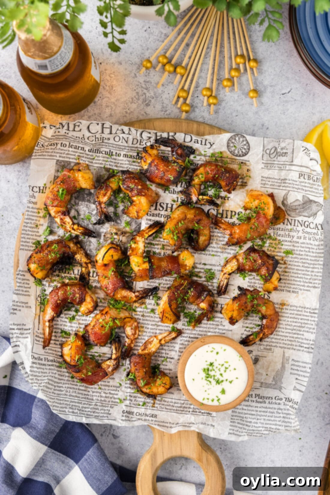 Crispy Air Fryer Bacon-Wrapped Shrimp 12 Air Fryer Bacon Wrapped Shrimp on a parchment lined board