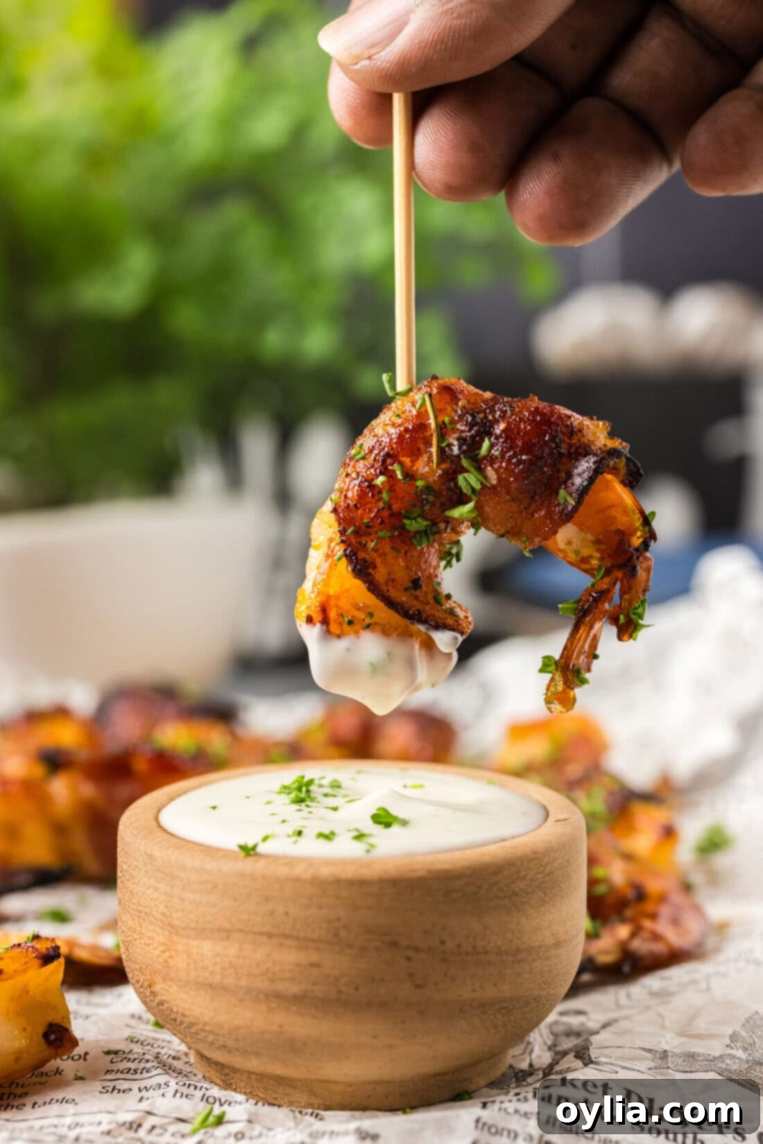 Crispy Air Fryer Bacon-Wrapped Shrimp 3 Air Fryer Bacon Wrapped Shrimp on a toothpick dipped in ranch