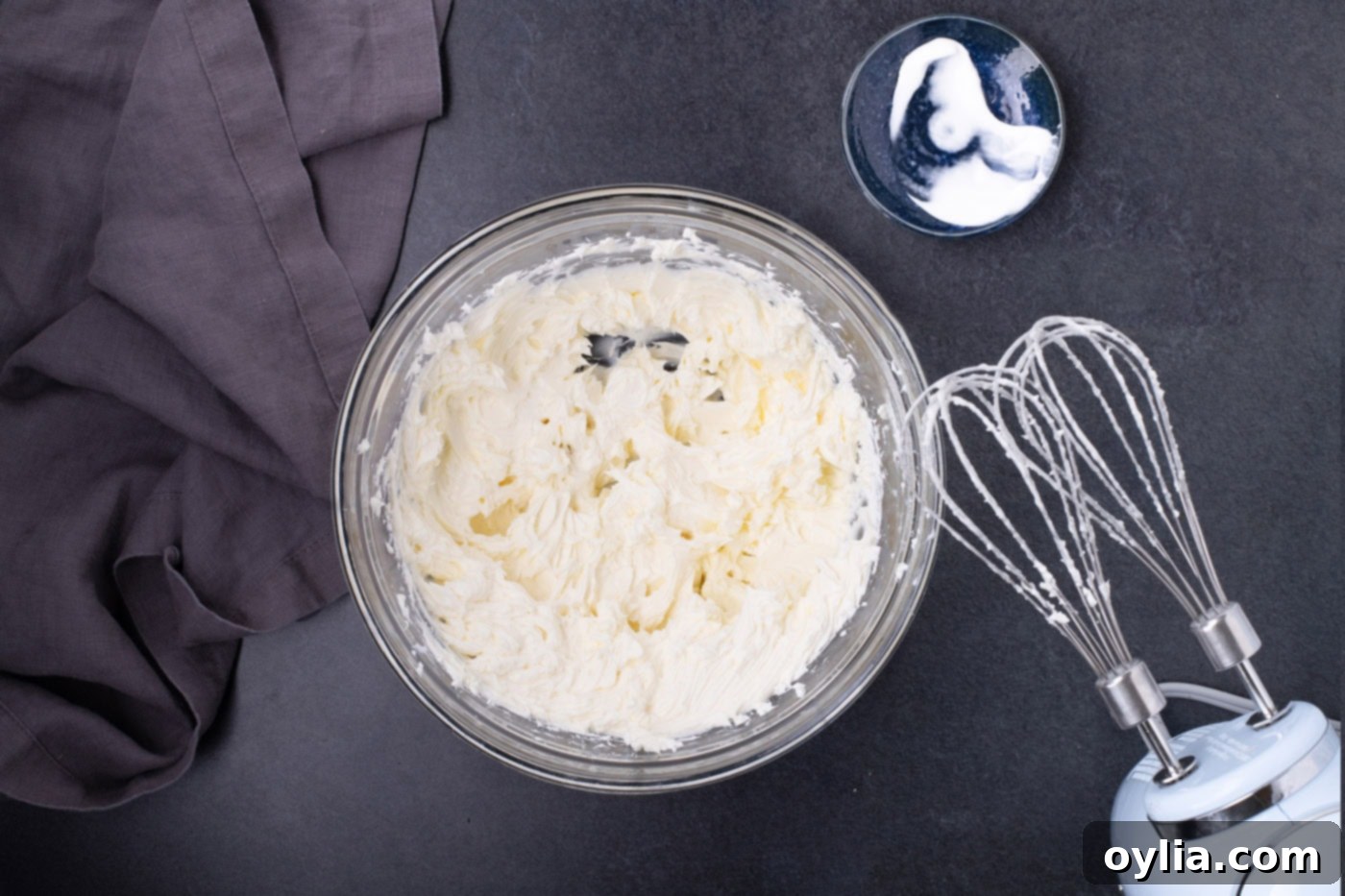 Creamy, fluffy beaten cream cheese and sour cream in a large mixing bowl