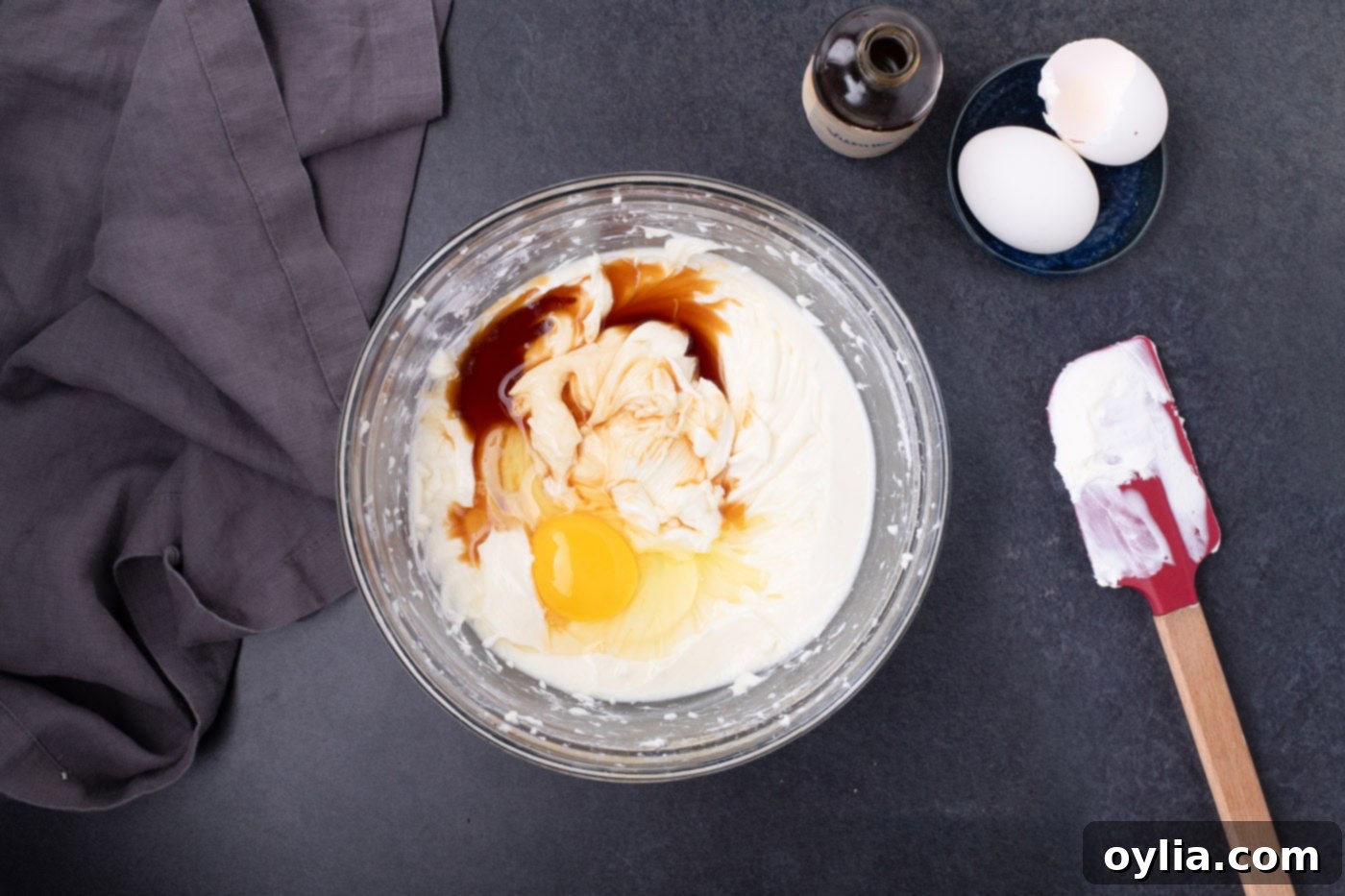 Eggs and vanilla extract gently folded into the smooth cheesecake batter