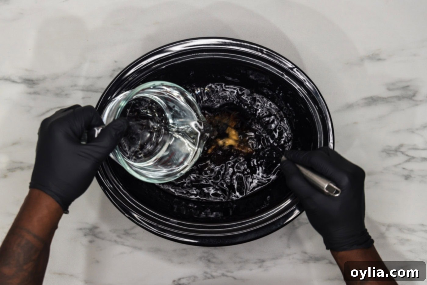 pouring water into crockpot of gravy liquids for short ribs