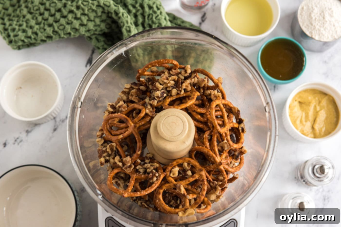 pretzels and walnuts in a food processor bowl, coarsely ground